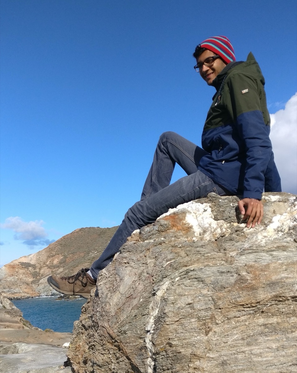 Raghav sitting on a rock